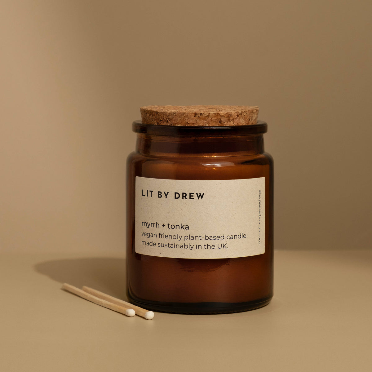 Myrrh and tonka natural scented candle in a brown glass jar with a sustainable cork lid.