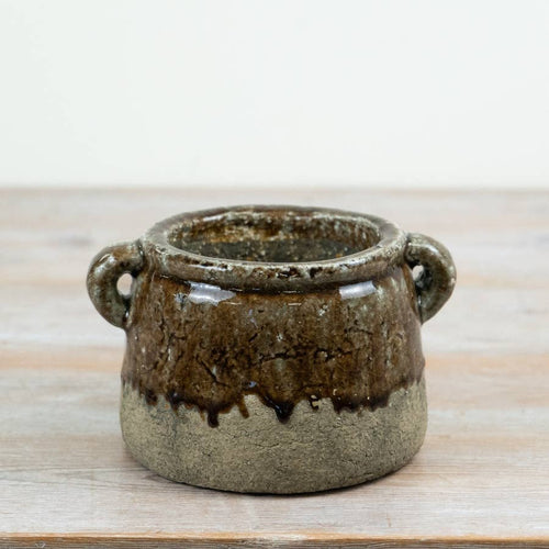 Agnes 18cm stoneware pot with loop handles, featuring a rustic reactive brown glaze and textured base styled on a wooden surface.