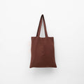 A dark brown linen tote bag with matching shoulder straps hanging against a plain white background.