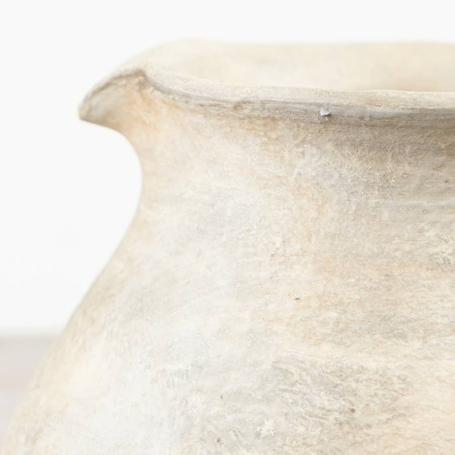 Close-up of the Cici terracotta jug vase showing its textured beige finish against a white background.