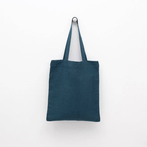 A deep water blue linen tote bag with matching shoulder straps displayed against a plain white background.