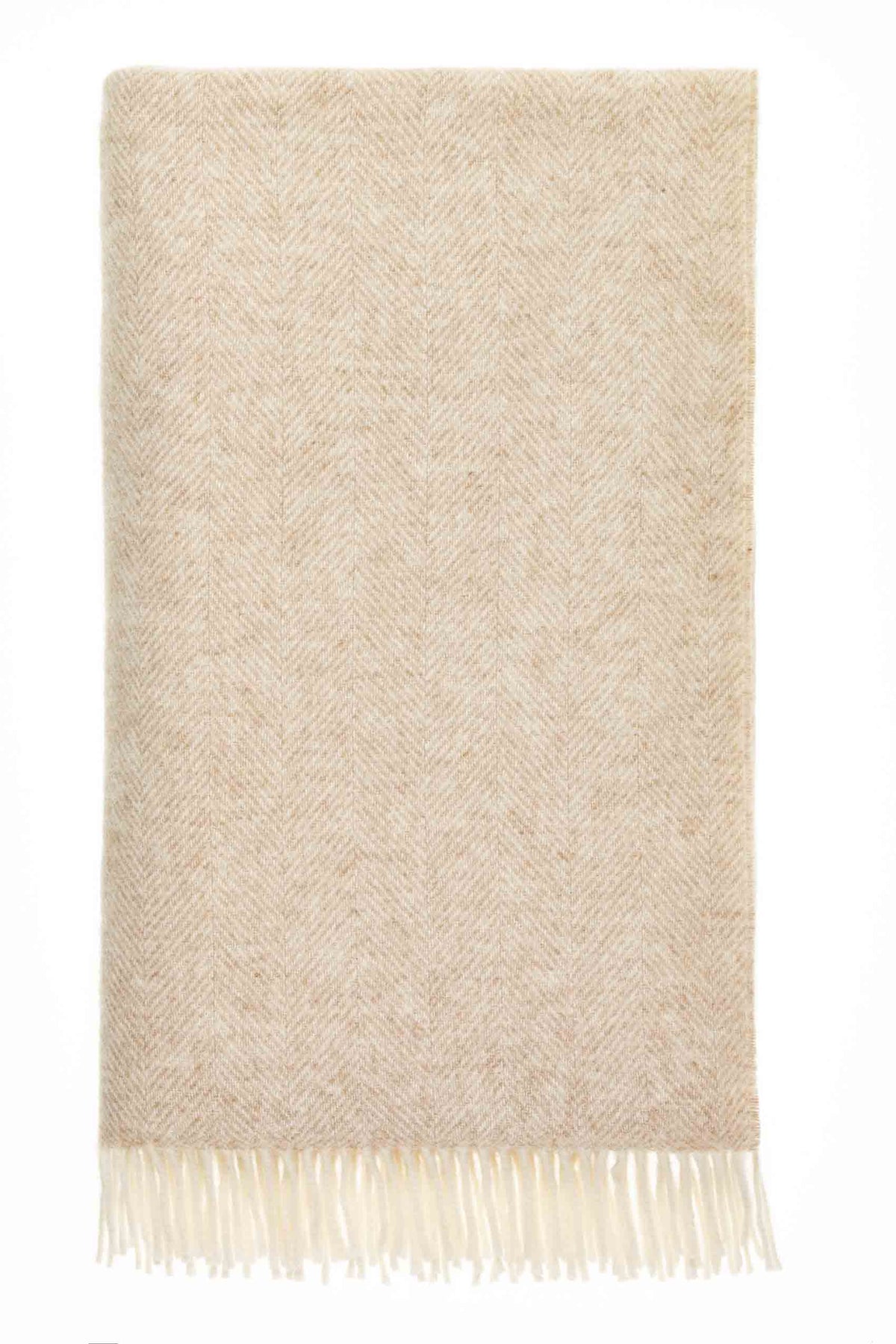 Beige and cream British wool throw in a classic herringbone weave with fringed edges, laid flat on a neutral background.