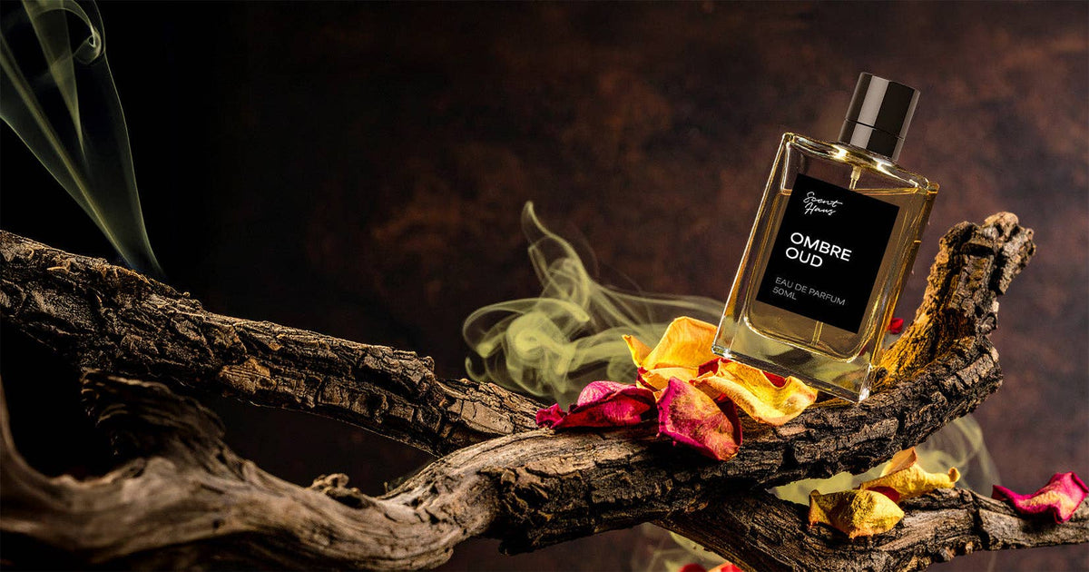 Perfume bottle labeled 'Ombre Sud' on a decorative wooden platform with flowers and smoke effects.