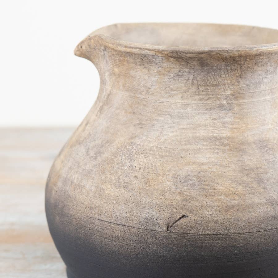 Close-up of the 21.5cm Oti terracotta jug vase showing its textured surface against a light background.