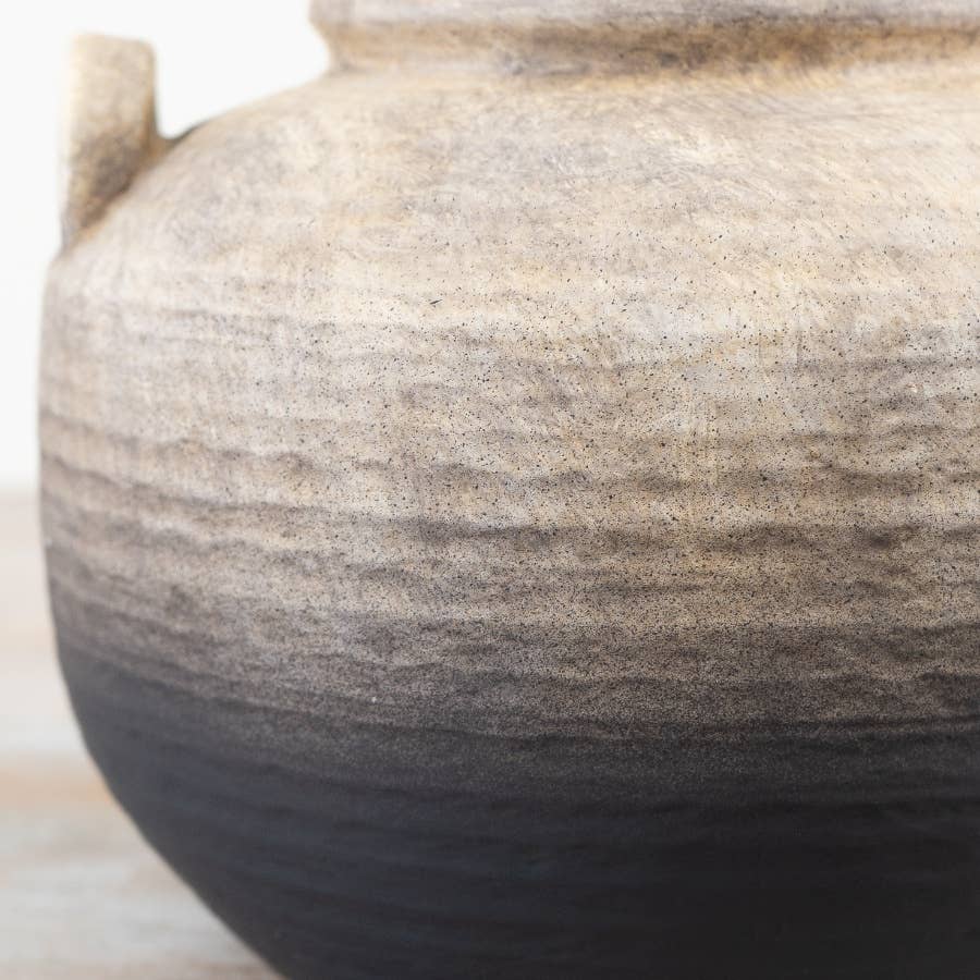 Close-up of the Oti terracotta vase showing its rustic texture and natural black ombre finish against a light background.