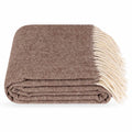 A folded brown Steppe merino wool throw blanket with cream fringe, shown on a clean white background.