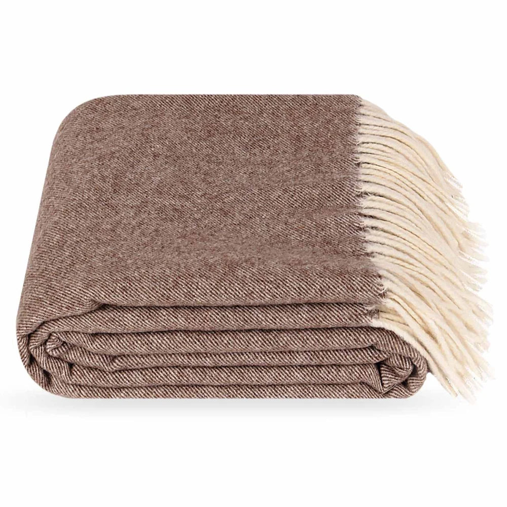 A folded brown Steppe merino wool throw blanket with cream fringe, shown on a clean white background.